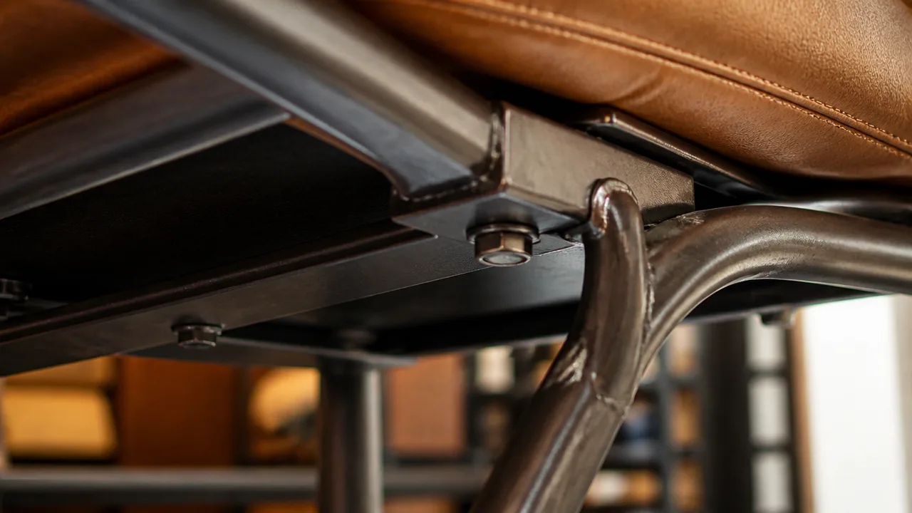 Close detail of a commercial chair joint and steel frame underside